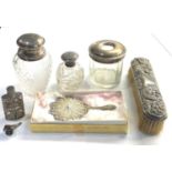 Silver items includes silver top bottles silver back brush small silver filigree mirror