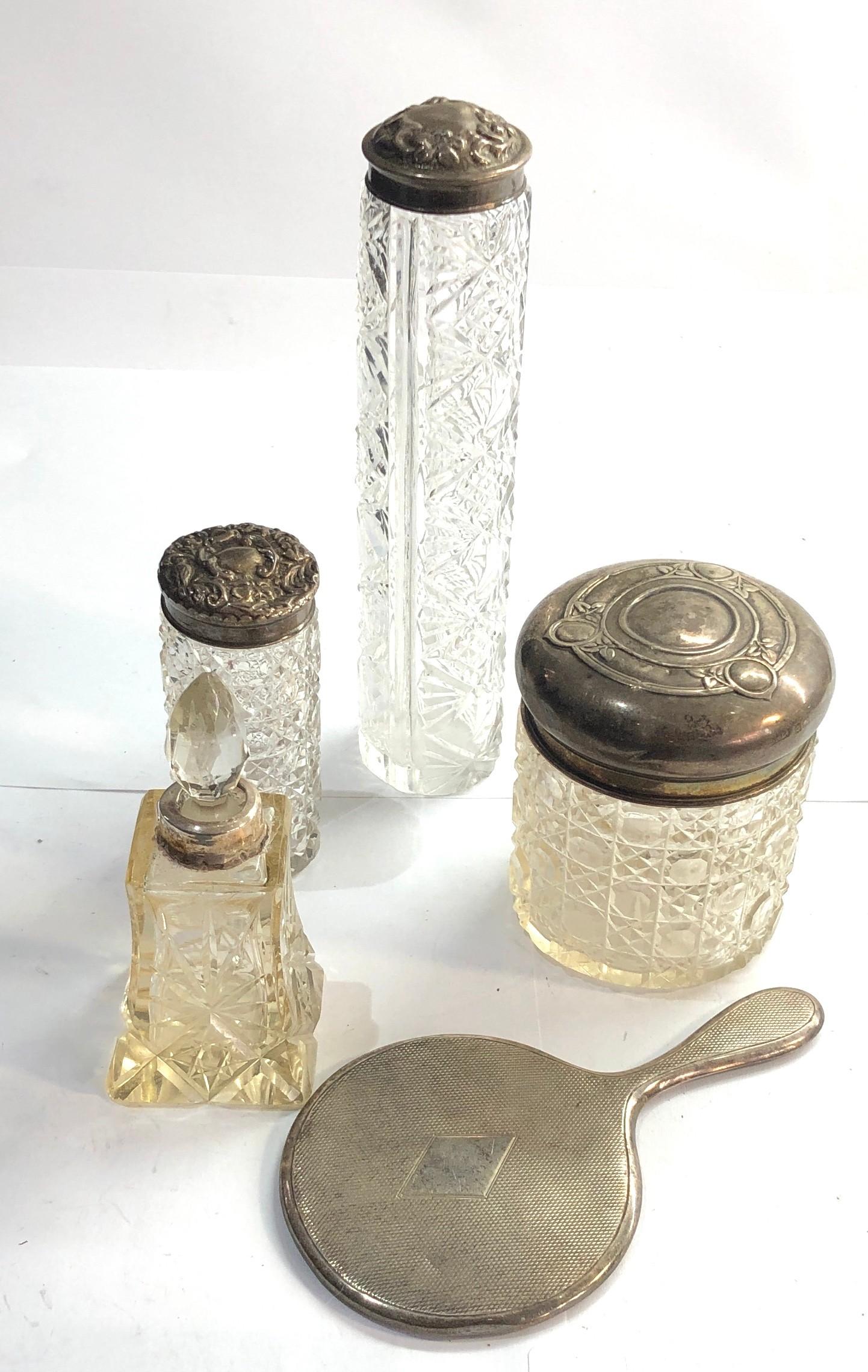 Selection of silver items includes silver top bottles and small silver mirror
