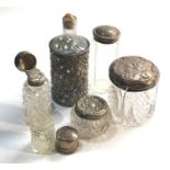 Selection of antique silver top jars and bottles