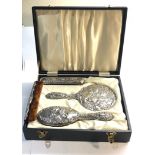 Boxed silver mirror and brush set with cherub embossed backs