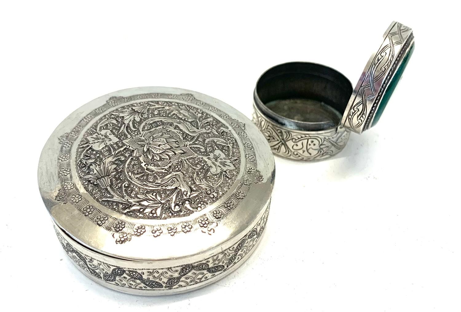 2 Persian silver boxes larget measures approx 6.3cm dia weight 90g the other set with green stone