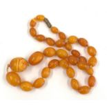Antique / vintage egg yolk amber bead necklace largest bead measures approx 22mm by 19mm weight 36.