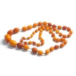 Antique egg yolk amber bead necklace largest bead measures approx 25mm by 19mm graduated beads