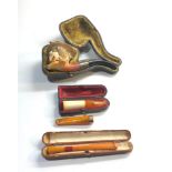 Selection of antique pipes and amber cheroot holders boxed