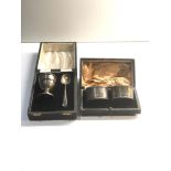 Boxed silver egg cup and spoon and pair of silver napkin rings