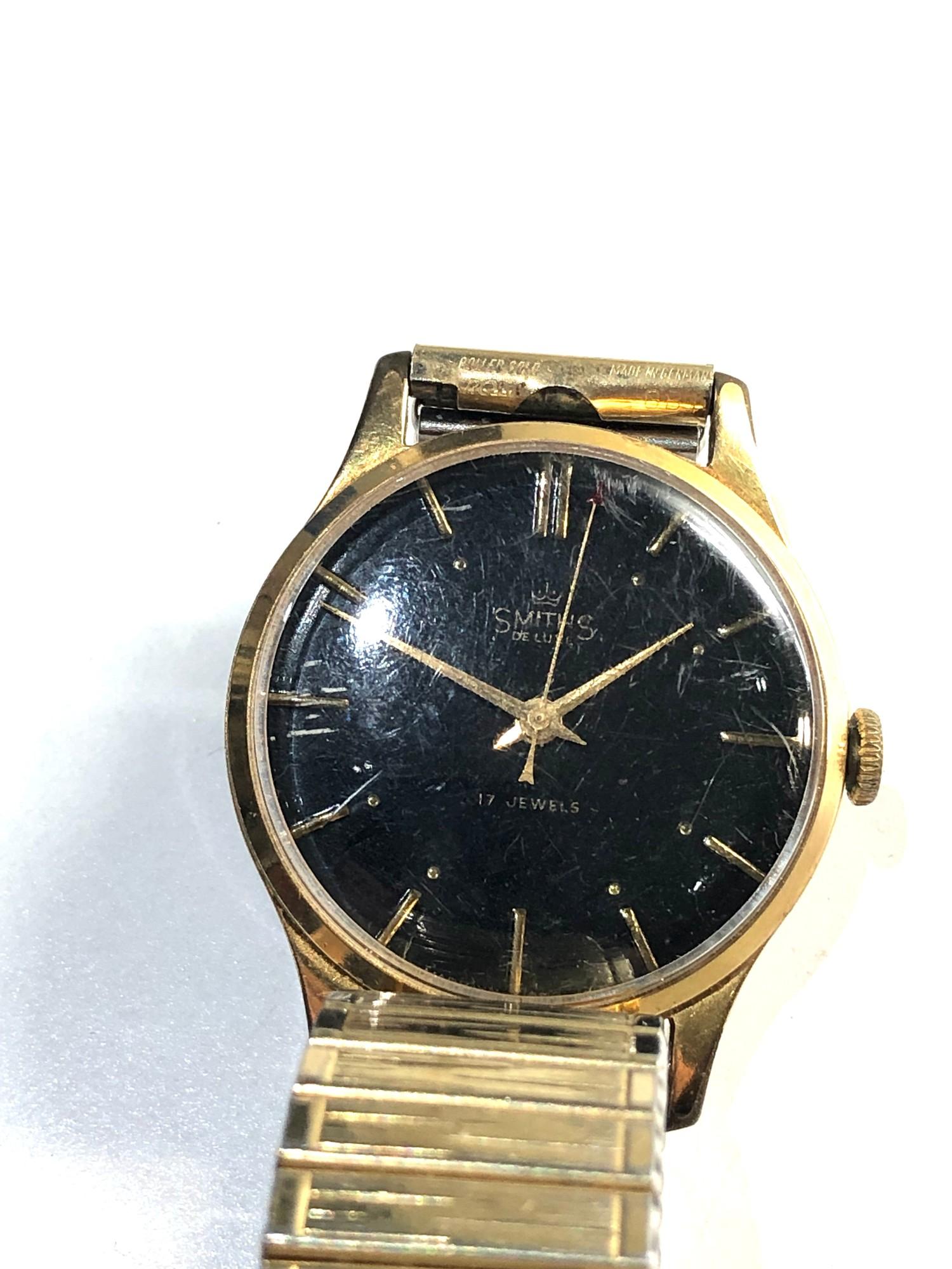 Vintage black dial smiths de luxe 17 jewel gents wrist watch winds and ticks but no warranty given