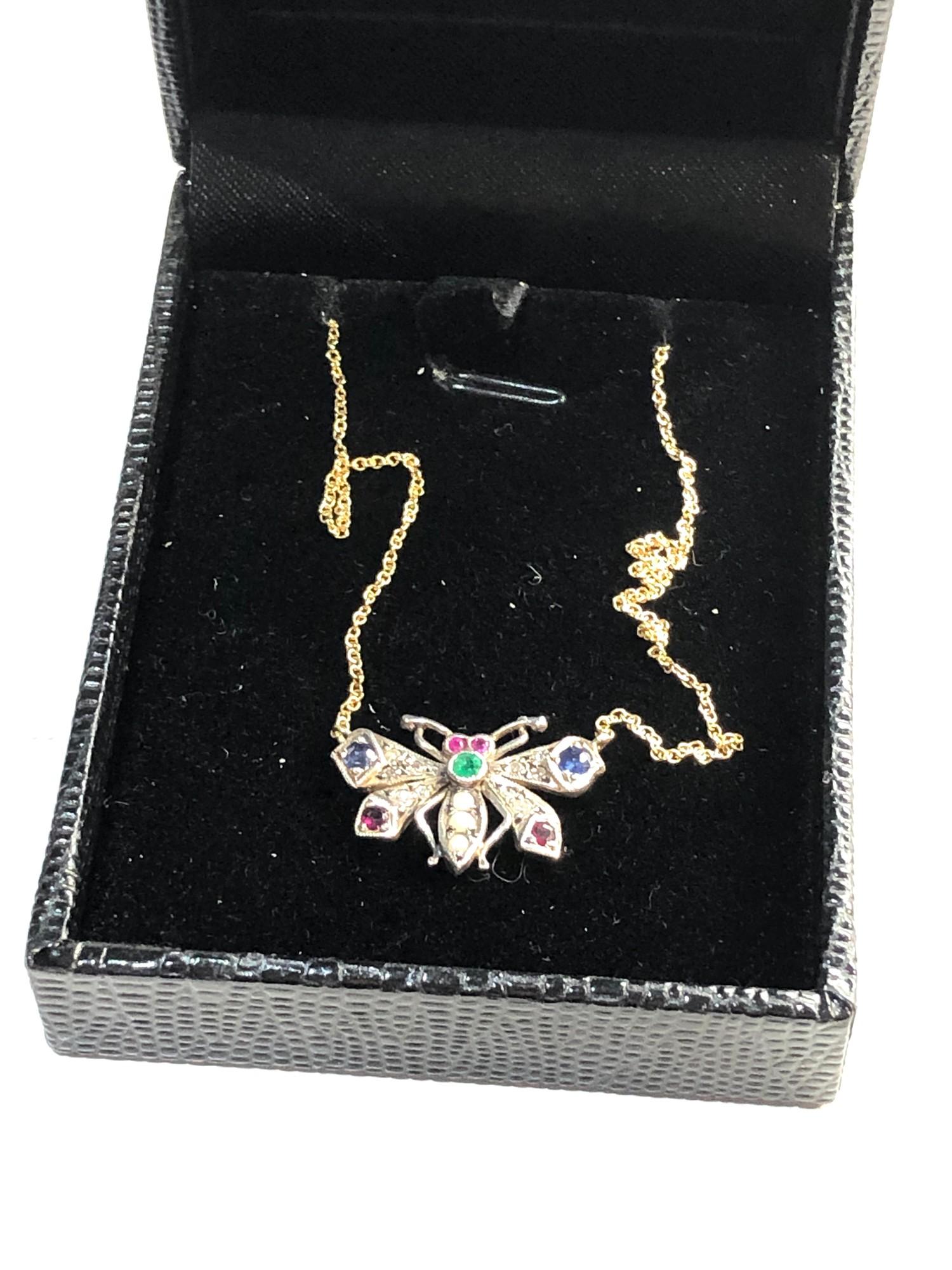 Rose diamond sapphire and gem set butterfly pendant on chain set in silver and gold measures