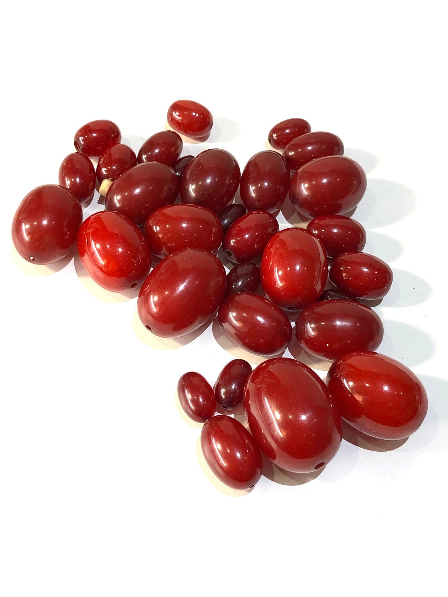 Antique cherry amber / bakelite beads largest bead measures approx 3.2cm by 2.4cm weight 115g good