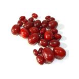 Antique cherry amber / bakelite beads largest bead measures approx 3.2cm by 2.4cm weight 115g good