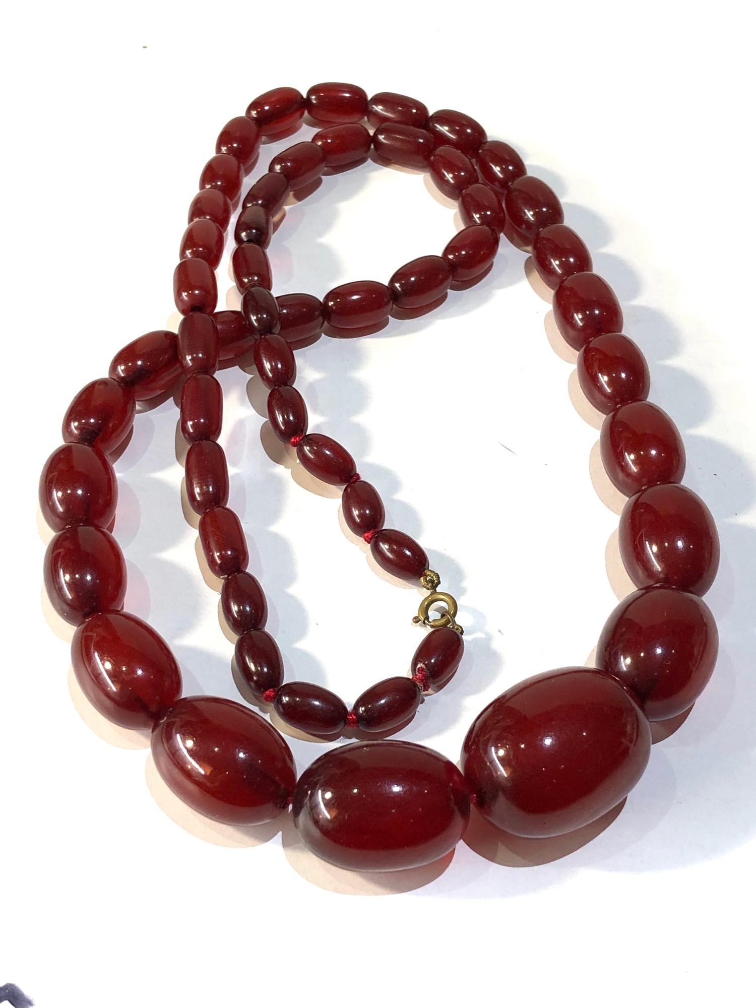 Antique cherry amber / bakelite bead necklace largest bead measures approx 3.1cm by 2.3cm weight 90g