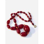 Vintage cherry amber bakelite necklace has internal swirls measures approx 48.cm long weight 25g