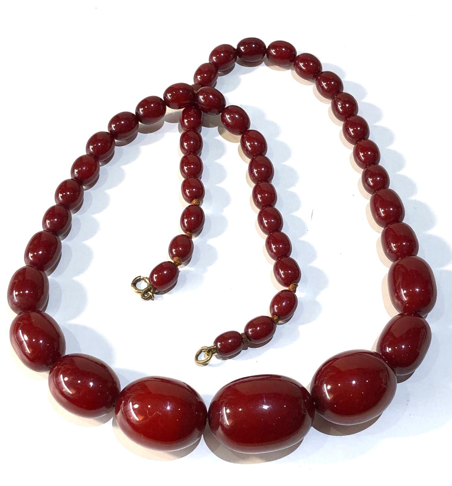 Antique cherry amber / bakelite bead necklace largest bead measures approx 3.2cm by 2.3cm weight 71g