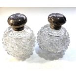Pair of antique silver top perfume bottles the silver tops are in need of restoration dents and