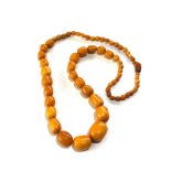 Antique egg yolk Amber bead necklace measures approx 84cm long largest bead measures approx 29mm