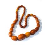 Antique egg yolk amber bead necklace largest bead measures appox 27mm by 17mm weight 54g will need