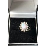 9ct gold opal ring with paste stones around good condition