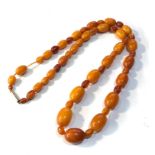 Antique egg yolk amber bead necklace weight 47g largest bead measures approx 22mm by 15mm