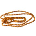 Long antique egg yolk amber bead necklace measures approx 176cm long even sized beads measures