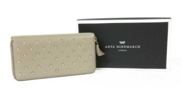 An Anya Hindmarch 'Joss' leather zip around studded wallet,