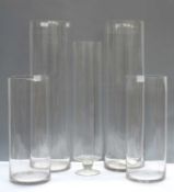 Five tall glass vases