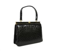 A vintage black crocodile leather handbag