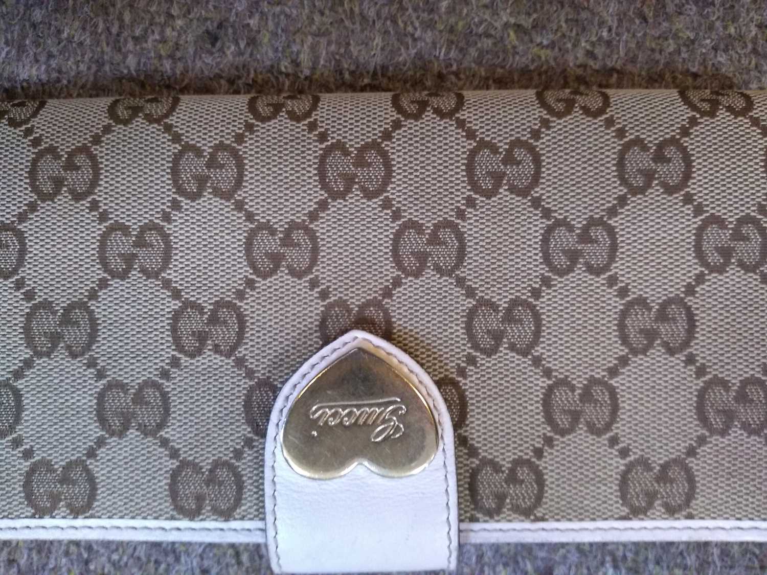 A Gucci beige monogrammed canvas and cream leather heart bi-fold wallet, - Image 13 of 13