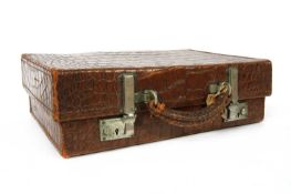 An early 20th century crocodile skin overnight case