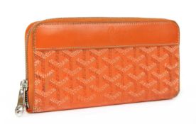 A Goyard orange canvas zippy wallet