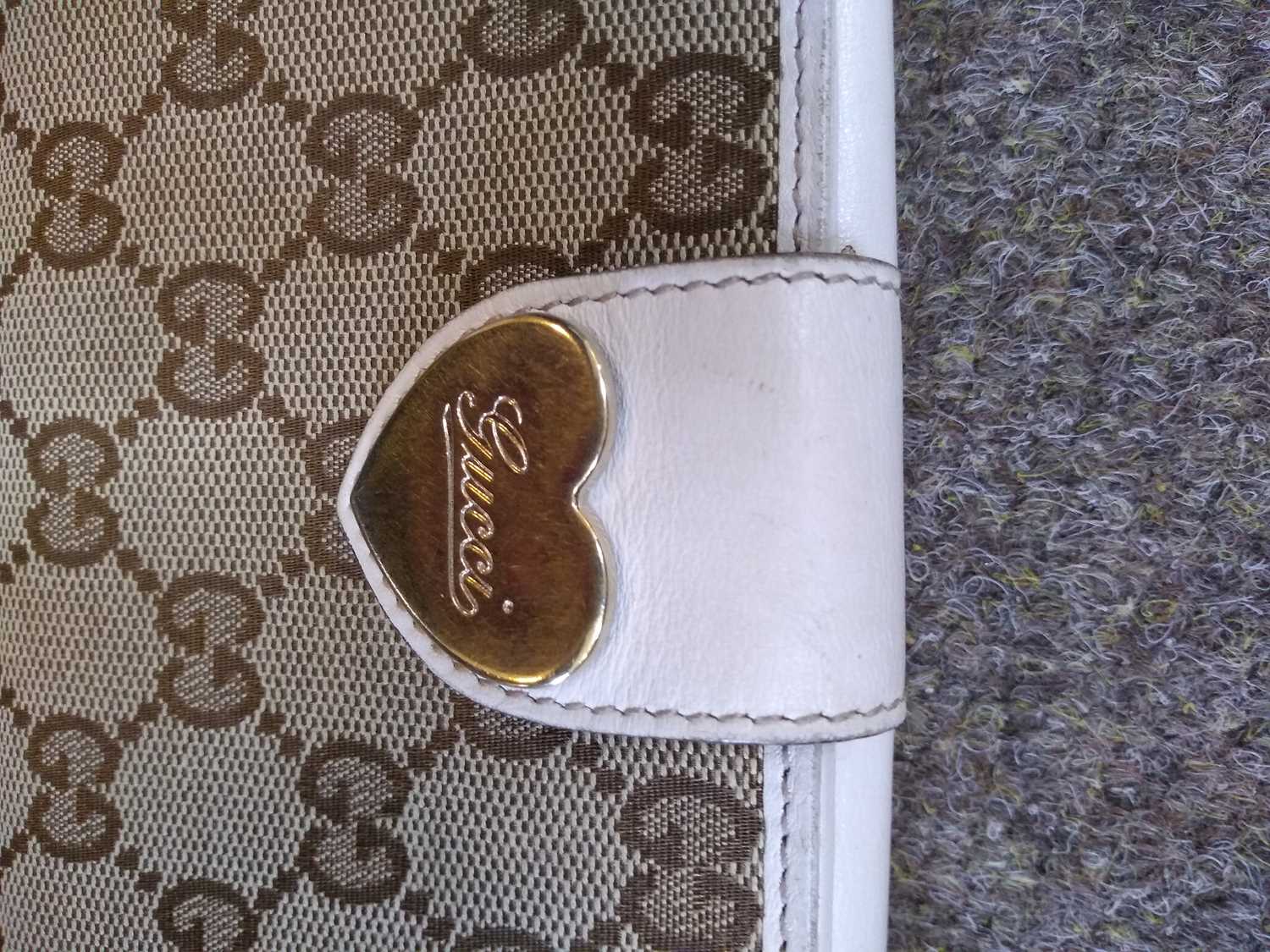 A Gucci beige monogrammed canvas and cream leather heart bi-fold wallet, - Image 2 of 13