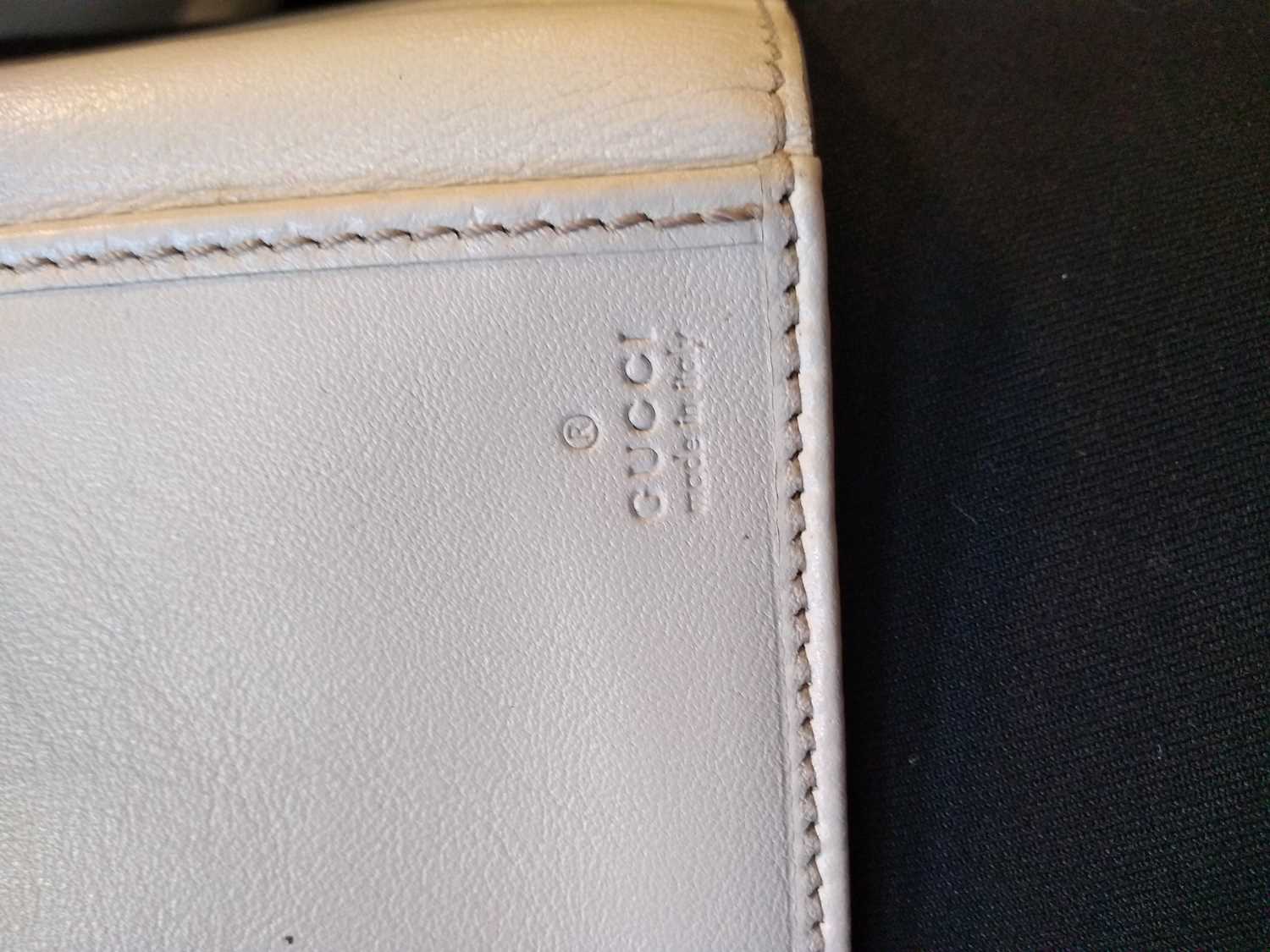 A Gucci beige monogrammed canvas and cream leather heart bi-fold wallet, - Image 9 of 13