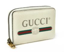 A Gucci cream, green and red leather zip wallet,