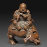 STATUETTE - en bambou sculpté, représentant un enfant bouvier assis sur son [...]