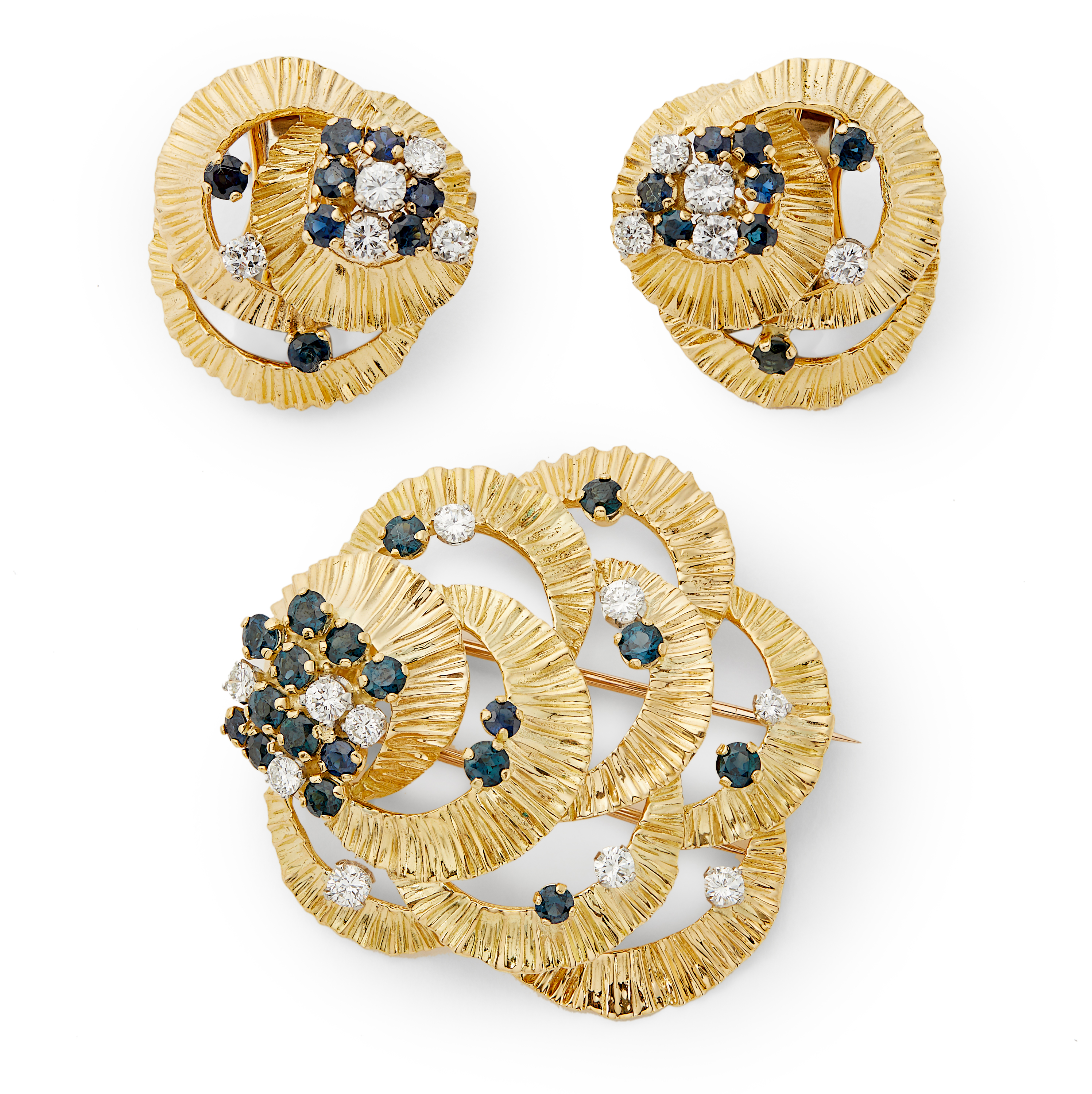 Kutchinsky - an 18ct gold sapphire and diamond brooch and stud earring suite.