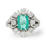 An emerald and diamond cluster ring.