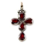 A foil-back garnet and diamond cross pendant.