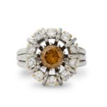 A fancy yellow-brown diamond and diamond cluster ring.