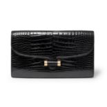 Yves Saint Laurent - a black patent crocodile Muse clutch bag.