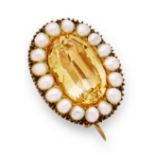 A mid 19th century foil back topaz and pearl brooch.