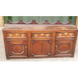 Early 18th Century Queen Anne Period Oak Dresser Base having shaped upstand to top over three frieze