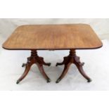 Late 18th Century mahogany twin pillar dining table having central supports and elegant four splay
