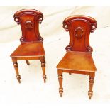 19th Century Victorian Mahogany Pair Of Hall Chairs having carved decoration to shield shaped