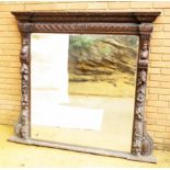 Imposing 19th Century Victorian Oak Overmantle Mirror having heavily carved frame enclosing bevelled