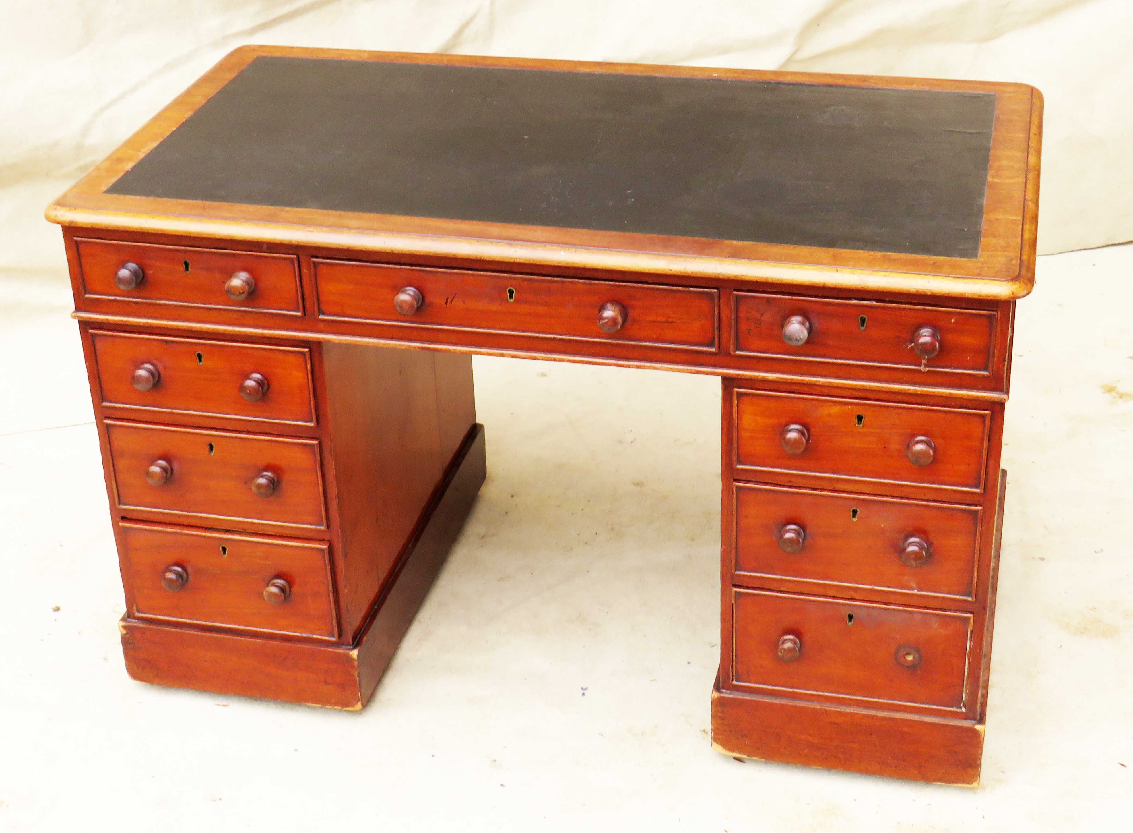 Mid 19th Century Mahogany Pedestal Desk of diminutive proportion having leather inset top over