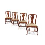 A set of four George I carved walnut side chairs