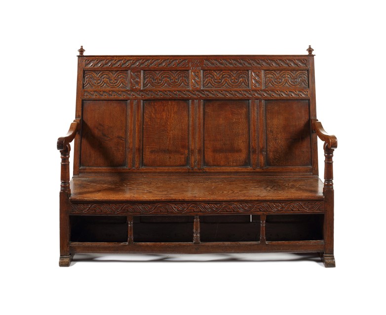 A James II carved oak and elm settle, dated 1688