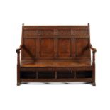 A James II carved oak and elm settle, dated 1688