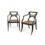 Two closely matched Regency ebonised and parcel gilt open armchairs