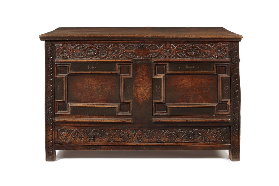 A James II carved oak and pewter inlaid panelled chest, dated 1688