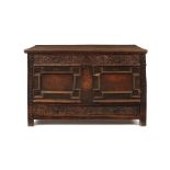 A James II carved oak and pewter inlaid panelled chest, dated 1688