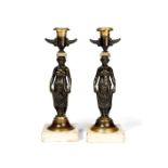 A pair of Empire gilt bronze and patinated bronze candlesticks